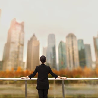 Woman starting at buildings