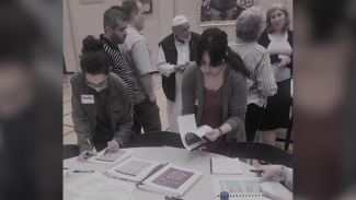 Rania distributing a guidebook for newly displaced refugees in Seattle.  